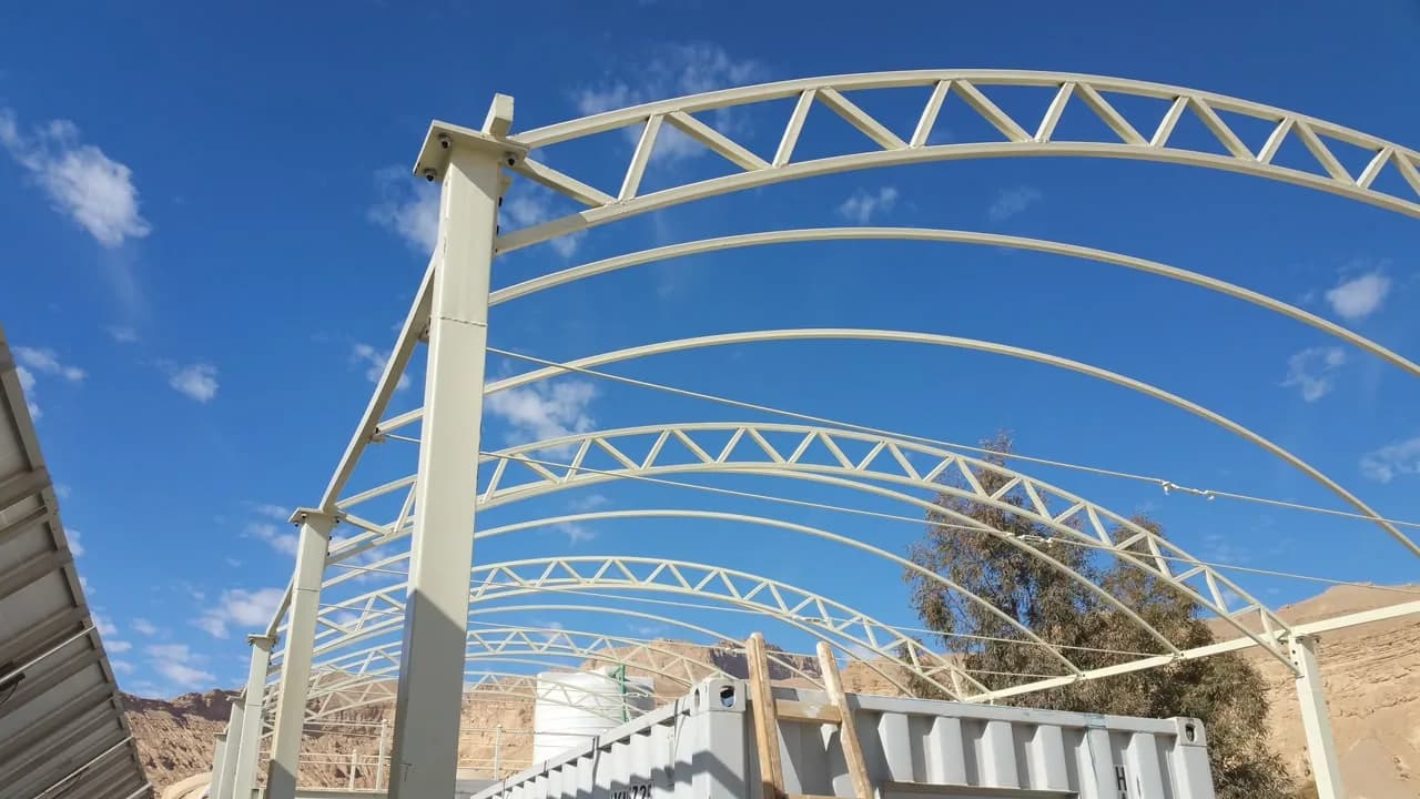 Arched steel truss canopy structure erected on site